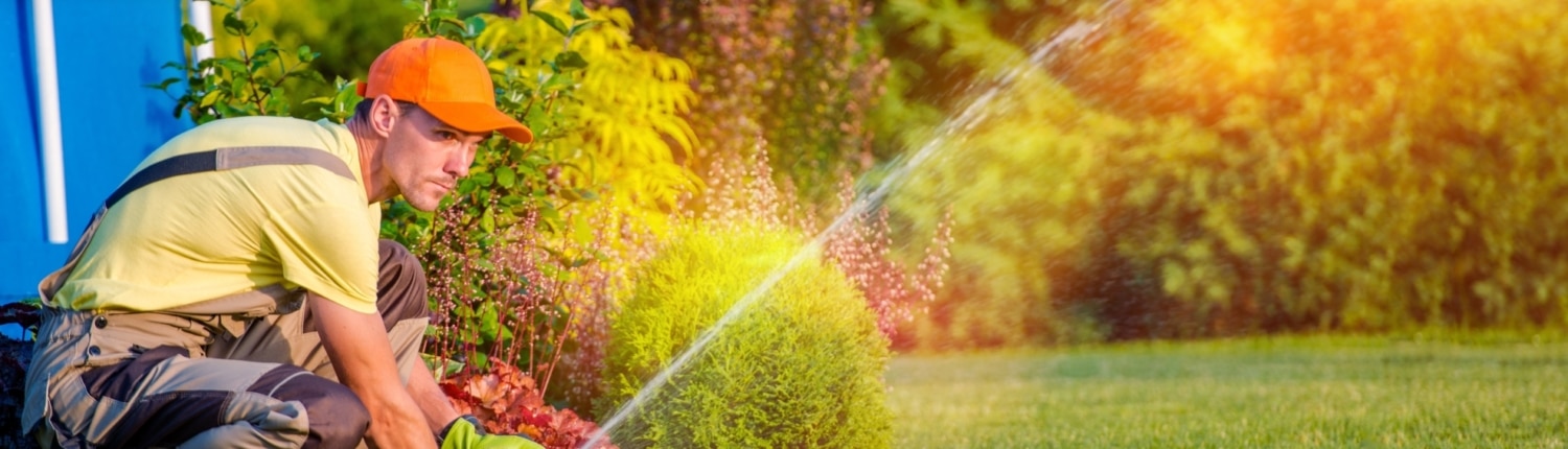 Garden Technician Testing Watering Sprinkler System in Utah